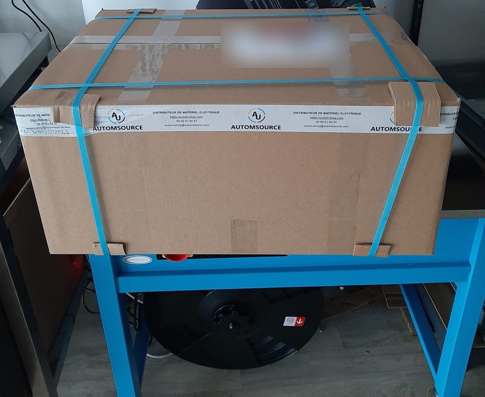 Colis AUTOMSOURCE cerclé, ruban d'expédition AUTOMSOURCE, prêt à partir